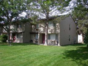 Caldwell apartment for rent - a large gray house with trees in front of it