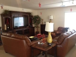 Caldwell apartment for rent - a living room with leather furniture and a television