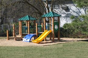 Boise apartment for rent - a playground with a swing set and slides