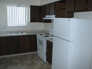 Boise apartment for rent - a kitchen with a white refrigerator and a sink