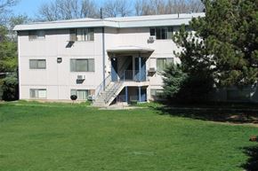Boise apartment for rent - a large white building with a lawn in front of it