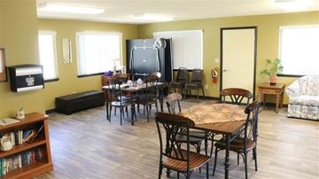 Fruitland apartment for rent - a living room with tables and chairs and a television