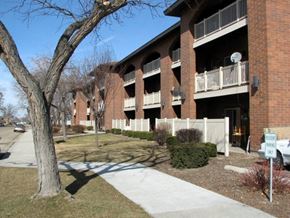 Caldwell apartment for rent - an apartment building with a sidewalk and a tree