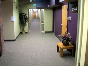Caldwell apartment for rent - a hallway with purple and white doors and a table with a plant