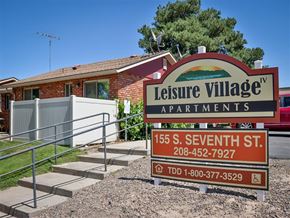 Payette apartment for rent - a sign for the leisure village apartments in front of a building