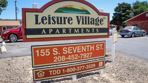 Payette apartment for rent - a sign for leasing village apartments on the side of a road