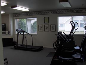 Nampa apartment for rent - a home gym with exercise equipment in a room with two windows