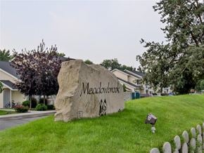 Emmett apartment for rent - a large rock sitting on the grass in front of a sign