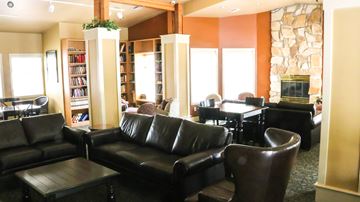 Boise apartment for rent - a living room with leather furniture and a fireplace