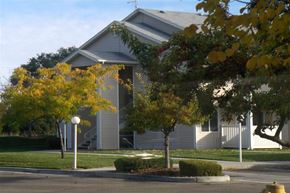 Nampa apartment for rent - a house with trees in front of it on a street