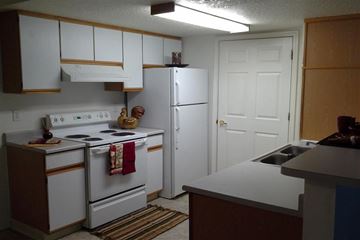 Nampa apartment for rent - a kitchen with white appliances and a refrigerator