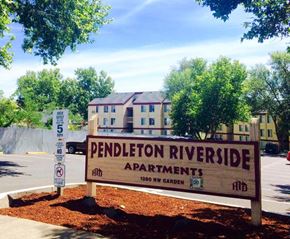 Pendleton apartment for rent - a sign apartments in front of a building