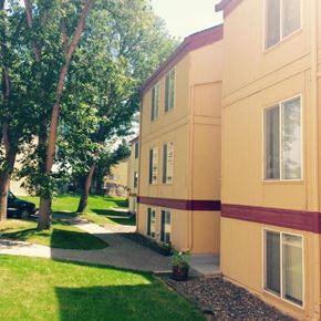 Pendleton apartment for rent - a building with a sidewalk and trees in front of it