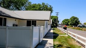Burley apartment for rent - a white building with a white fence next to a street