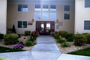 Caldwell apartment for rent - a walkway in front of a building with flowers