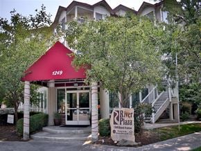 Boise apartment for rent - a building with a red roof and a sign in front of it