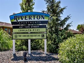 Heyburn apartment for rent - a sign for riverton apartments is shown in front of trees