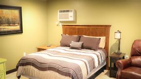 Heyburn apartment for rent - a bedroom with a bed and a air conditioning unit on the wall