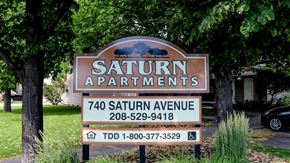 Idaho Falls apartment for rent - a sign for saturn apartments in front of some trees