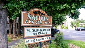 Idaho Falls apartment for rent - a sign for the saturn apartments on the side of the street