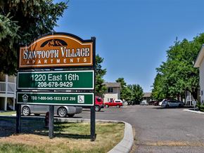Burley apartment for rent - a sign for the sanford village apartments on the corner of a street