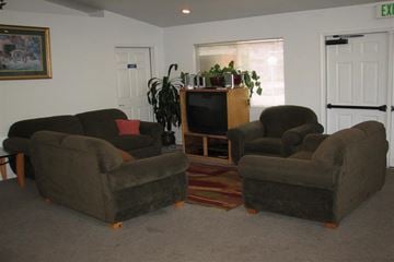 Garden City apartment for rent - a living room with three chairs and a television
