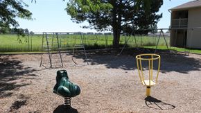 Rupert apartment for rent - a playground with a swing set and a frisbee