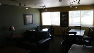Rupert apartment for rent - a living room with leather furniture and a table and chairs