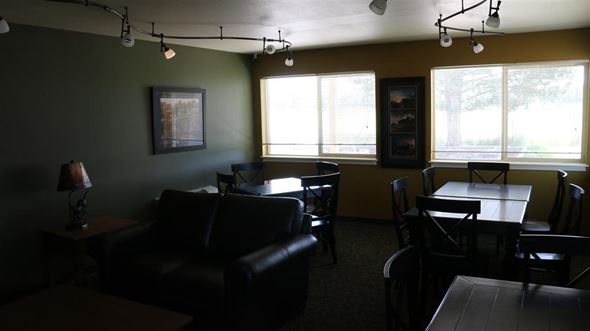 Rupert apartment for rent - a living room with leather furniture and a table and chairs