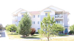 Idaho Falls apartment for rent - the exterior of an apartment building with trees in front of it