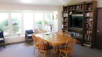 Mountain Home apartment for rent - a dining room with a wooden table and chairs and bookshelves