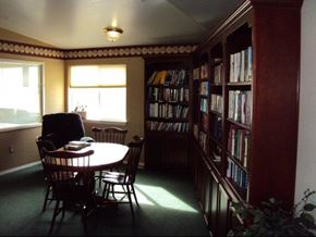 Lewiston apartment for rent - a dining room with a table and chairs and a library