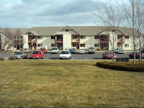 Lewiston apartment for rent - a parking lot with cars in front of a building