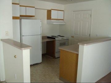 Lewiston apartment for rent - an empty kitchen with a refrigerator and a stove