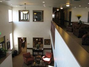 Fruitland apartment for rent - a lobby with couches and chairs and a staircase