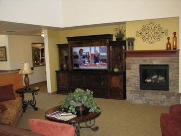Fruitland apartment for rent - a living room with a television and a fireplace