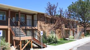 Rupert apartment for rent - the front of an apartment building with stairs and a porch