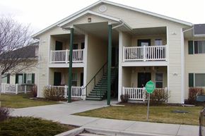 Kuna apartment for rent - a white house with stairs and a green sign