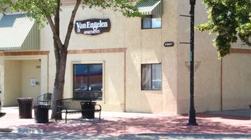 Nampa apartment for rent - a building with a bench and a tree in front of it