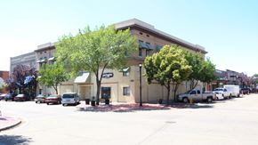 Nampa apartment for rent - an office building with a parking lot and trees