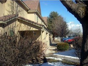 Boise apartment for rent - a yellow house with a snow covered sidewalk