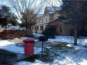 Boise apartment for rent - a red trash can in front of a house in the snow