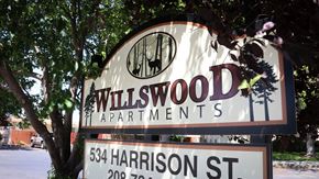 Twin Falls apartment for rent - a sign for millwood apartments in front of a tree