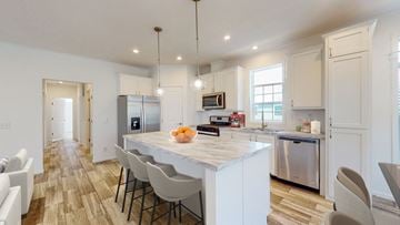 Oronoco apartment for rent - a kitchen with a marble counter top and white cabinets