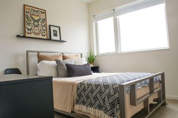 Milwaukee apartment for rent - a bedroom with a bed and a dresser and a window