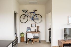Milwaukee apartment for rent - a bicycle hanging on a wall above a desk in a room