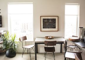 Milwaukee apartment for rent - a dining room with a table and chairs and a painting on the wall