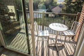 Mequon apartment for rent - a patio with a table and chairs on a balcony