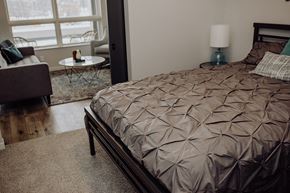 Grand Rapids apartment for rent - a bedroom with a bed and a chair and a table