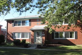 Tonawanda apartment for rent - A red brick house with a white door and windows.